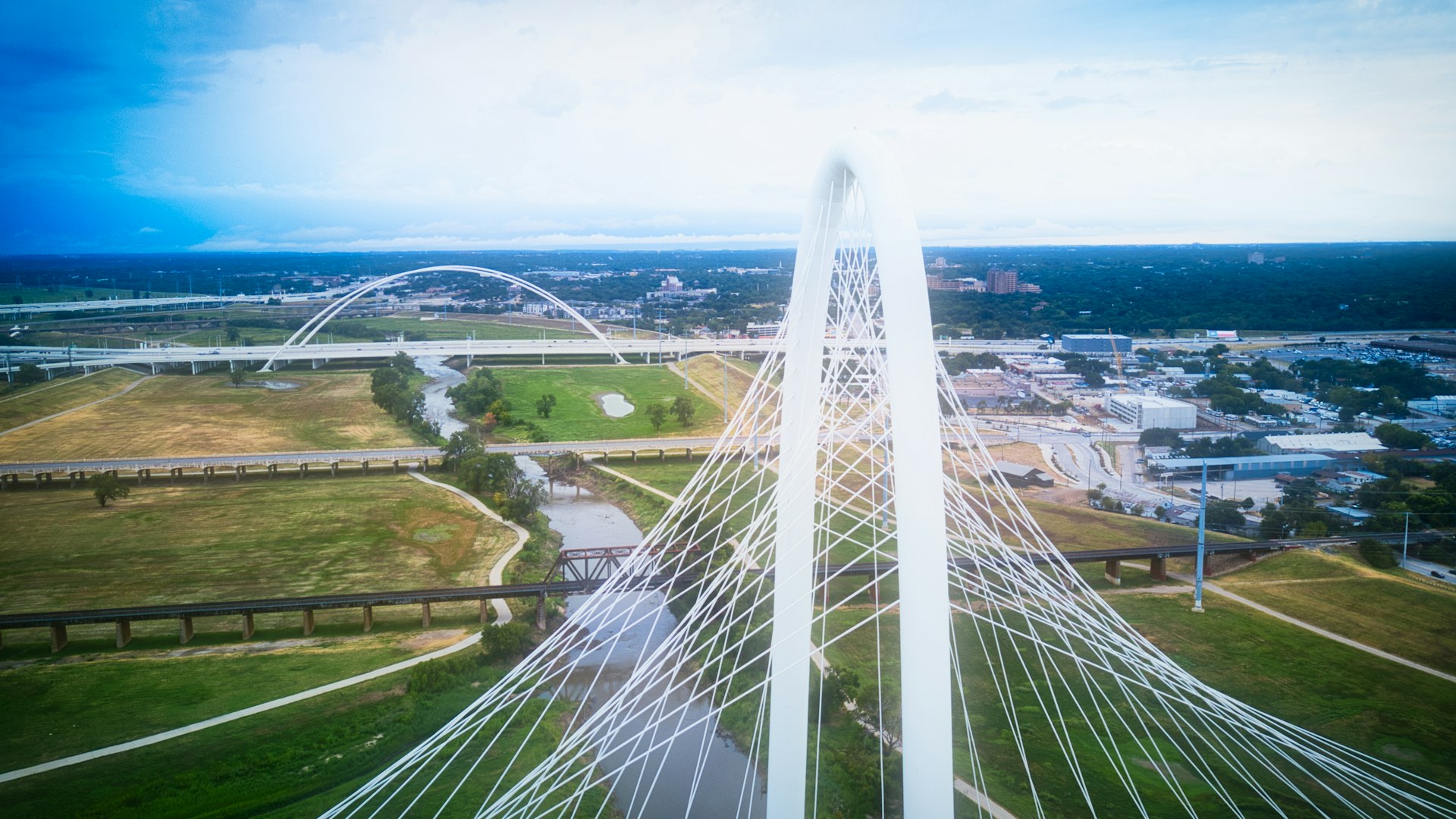 High-voltage transmission lines crossing a Texas industrial landscape, representing the infrastructure behind commercial electricity rates.