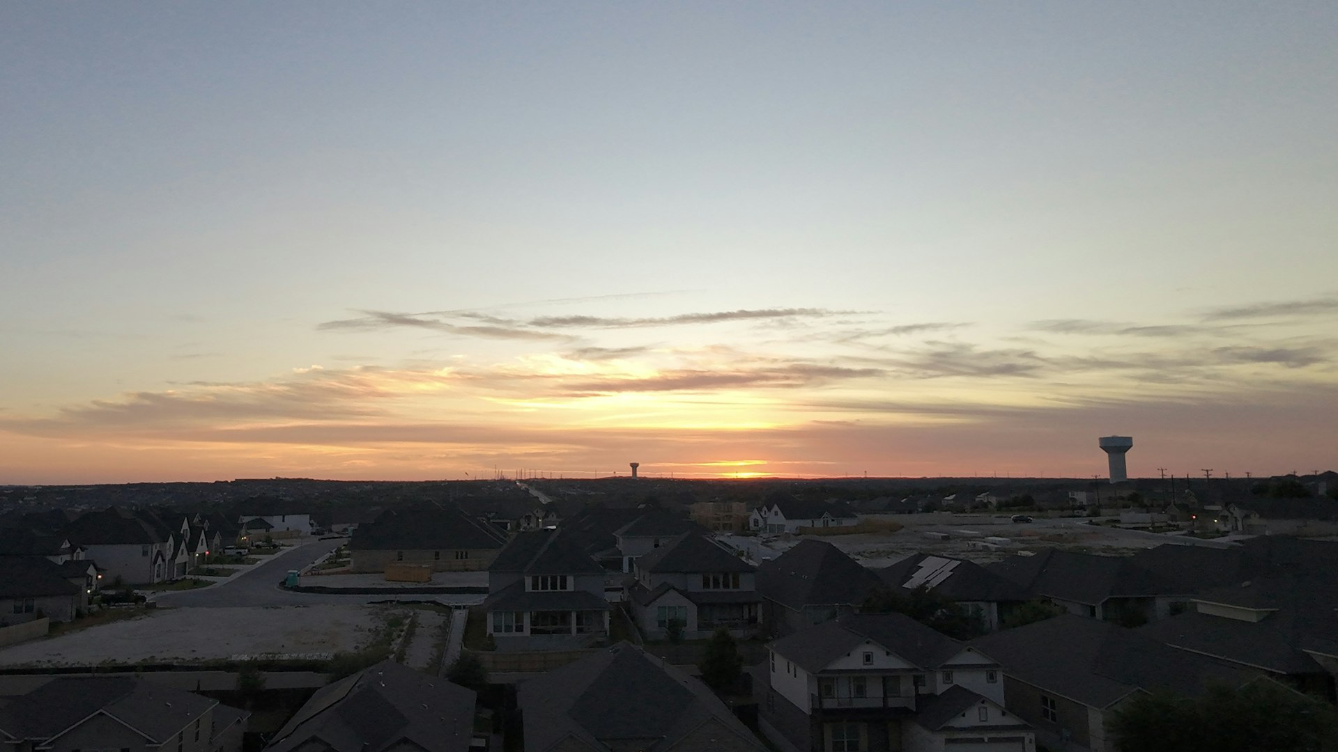 Texas high-voltage transmission infrastructure at sunset, representing commercial electricity rate trends across the ERCOT grid